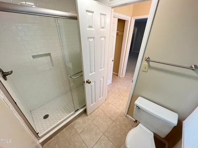 a bathroom with a glass door shower