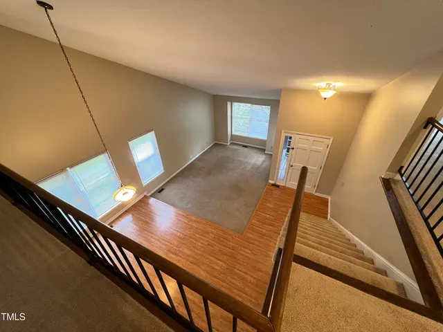 a view of an empty room with wooden floor