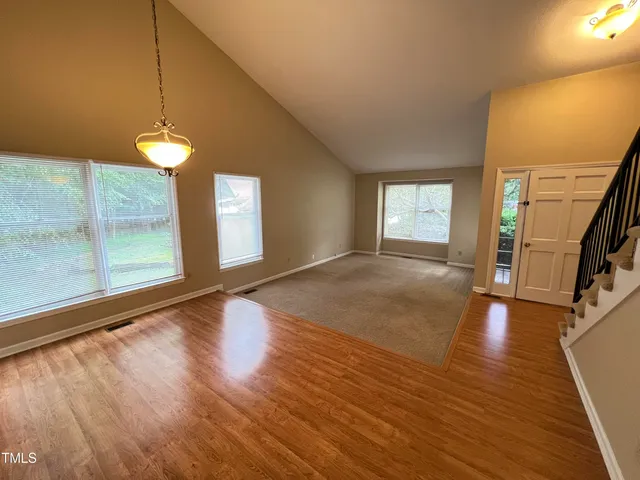 a view of a room with wooden floor and a window