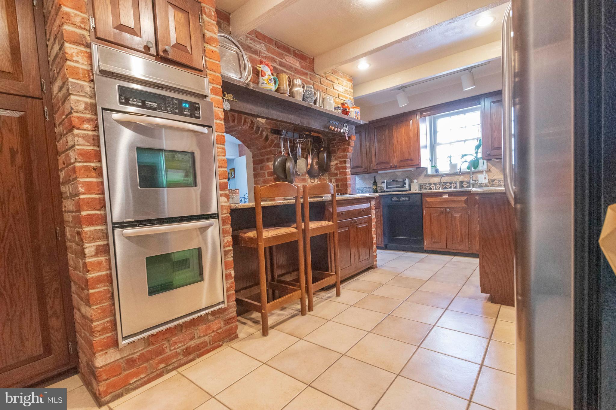 540 Putnam Road Merion Station, PA 19066 - Photo 12 of 32 a kitchen with stainless steel appliances granite countertop a stove a sink and a microwave