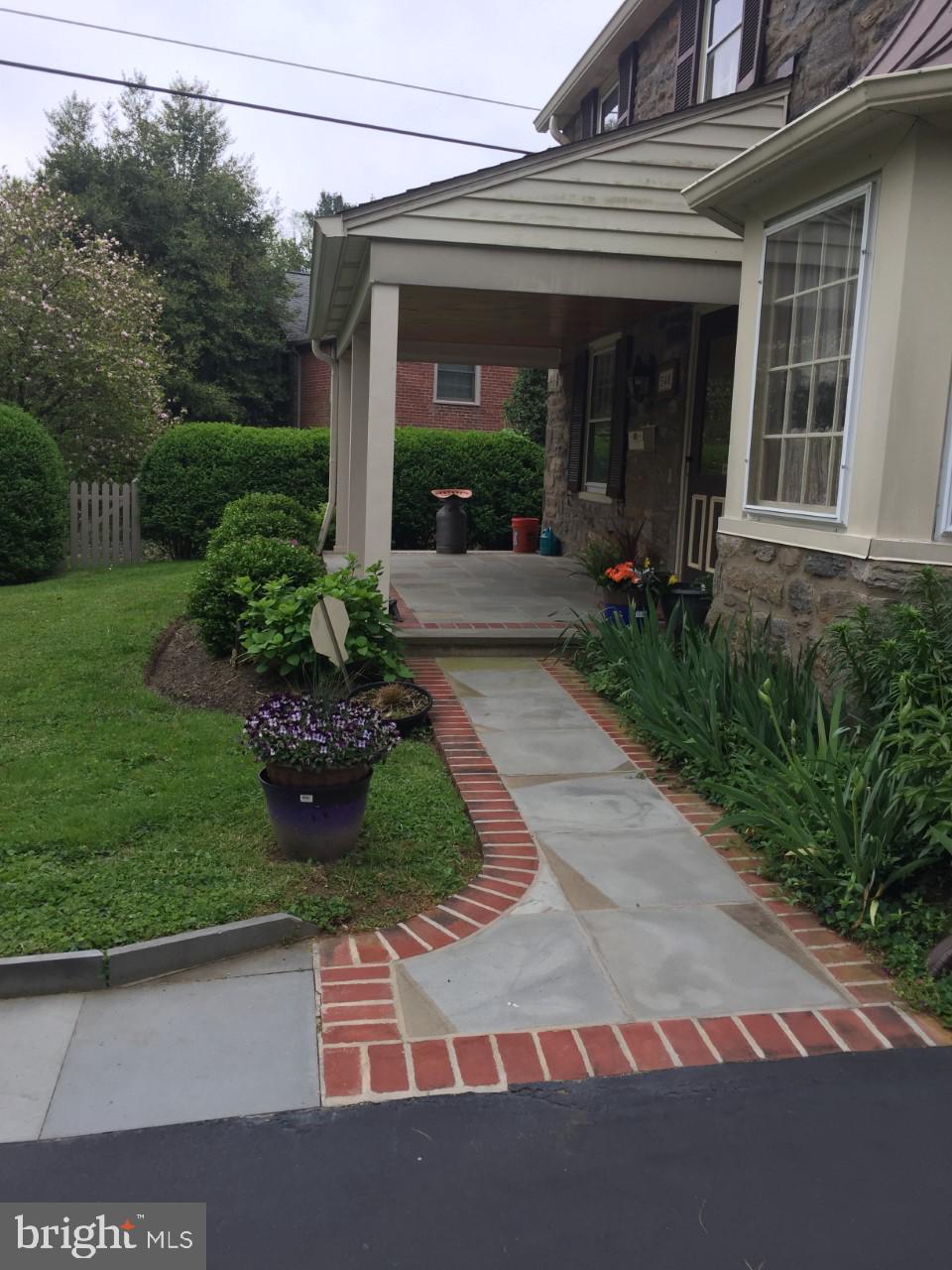540 Putnam Road Merion Station, PA 19066 - Photo 3 of 32 a view of a house with potted plants and a pathway