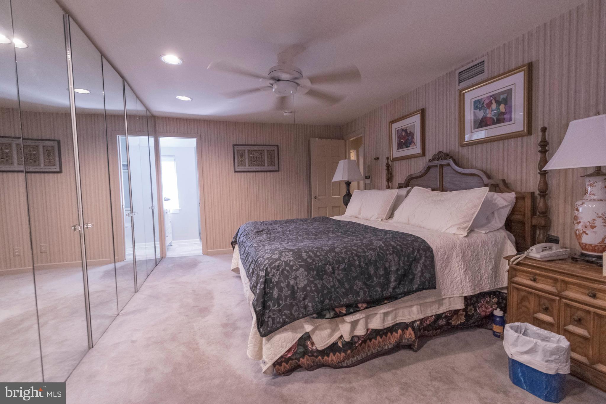 540 Putnam Road Merion Station, PA 19066 - Photo 25 of 32 a spacious bedroom with a bed and a chandelier