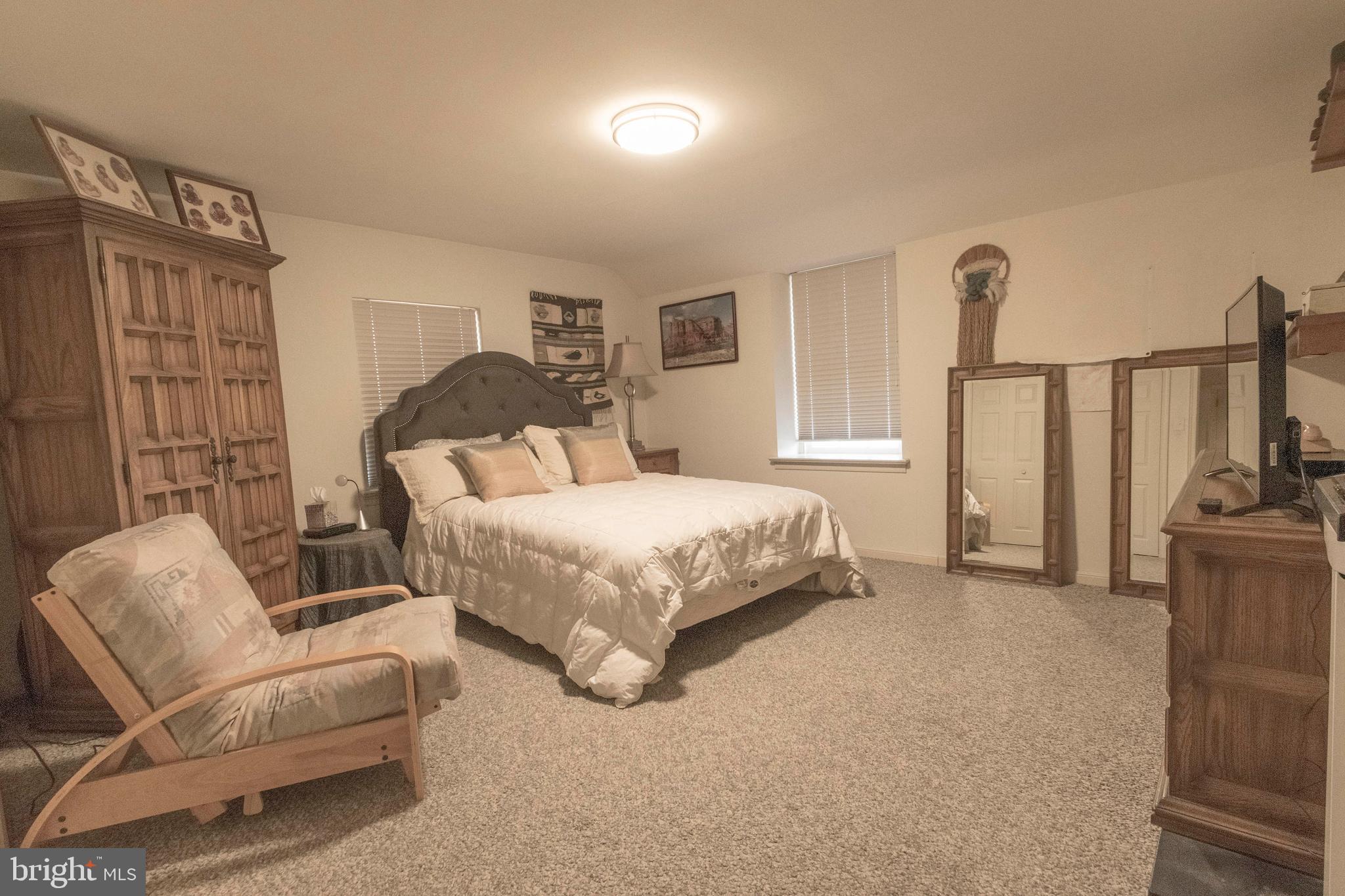 540 Putnam Road Merion Station, PA 19066 - Photo 28 of 32 a bedroom with a bed a couch and dresser