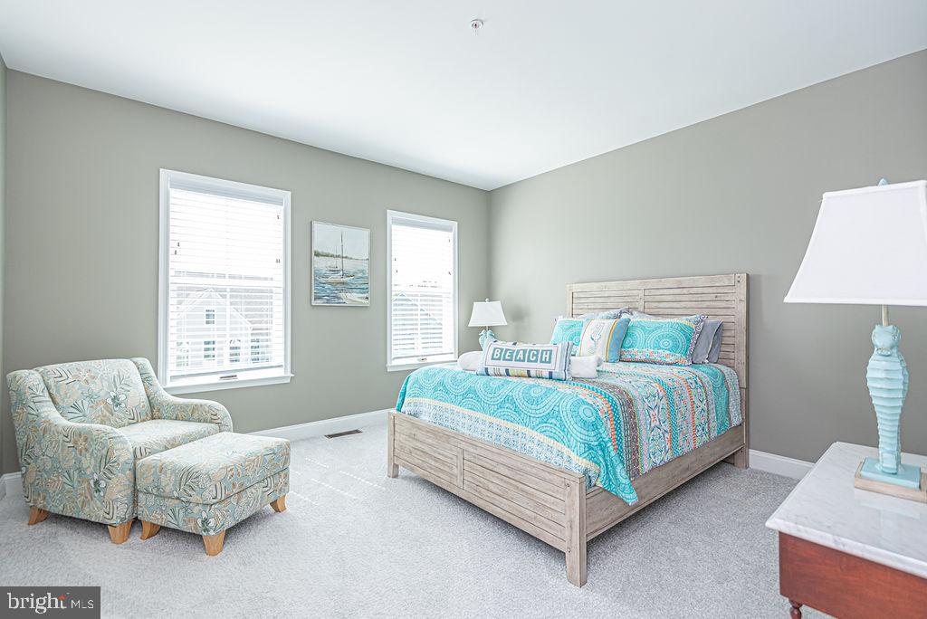 10214 Battle Colors Lane Berlin, MD 21811 - Photo 35 of 77 a spacious bedroom with a bed and a couch
