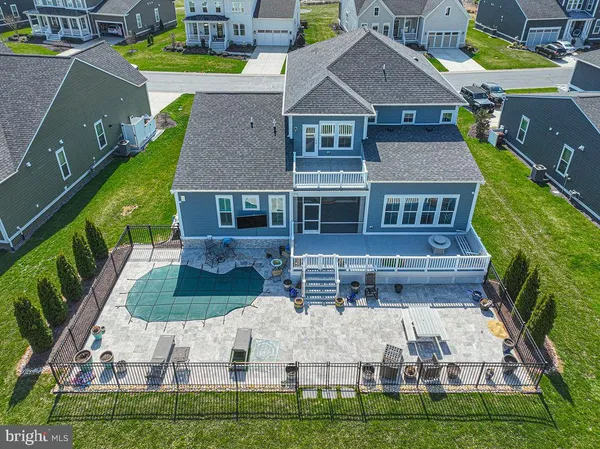 a large dining hall with stainless steel appliances granite countertop a stove a sink a dining table and chairs with wooden floor