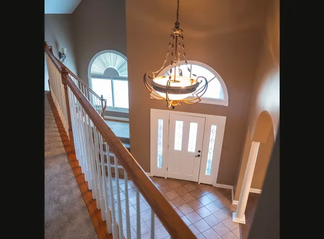a view of a livingroom with wooden floor and stairs