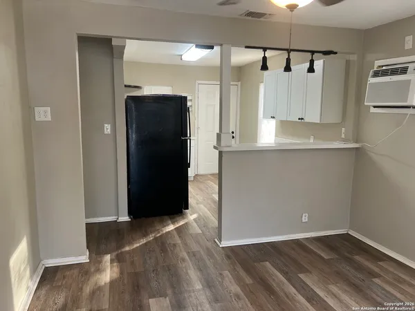 a view of a kitchen with wooden floor
