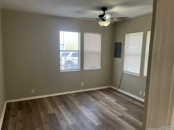 wooden floor in an empty room with a window