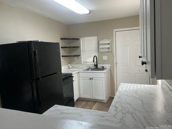 a kitchen with a refrigerator and cabinets