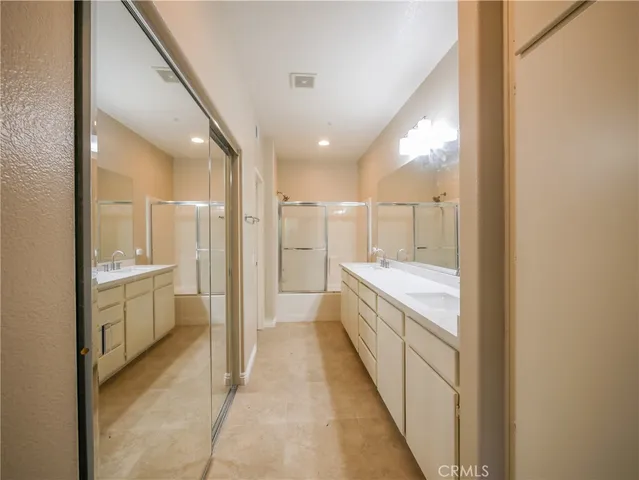 a bathroom with a glass shower door and a sink