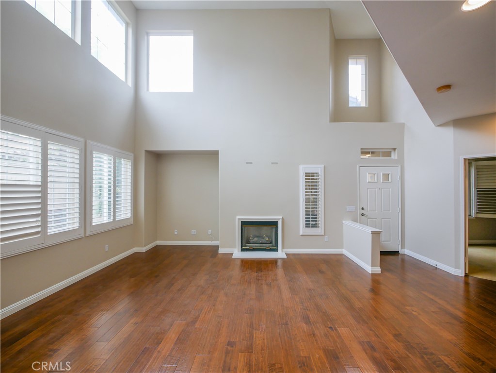 67 Ardmore Irvine, CA 92602 - Photo 3 of 16 an empty room with wooden floor and windows