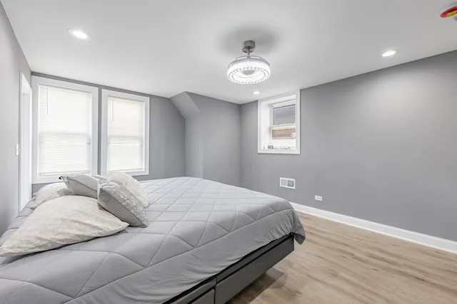 a bedroom with a large bed and a window