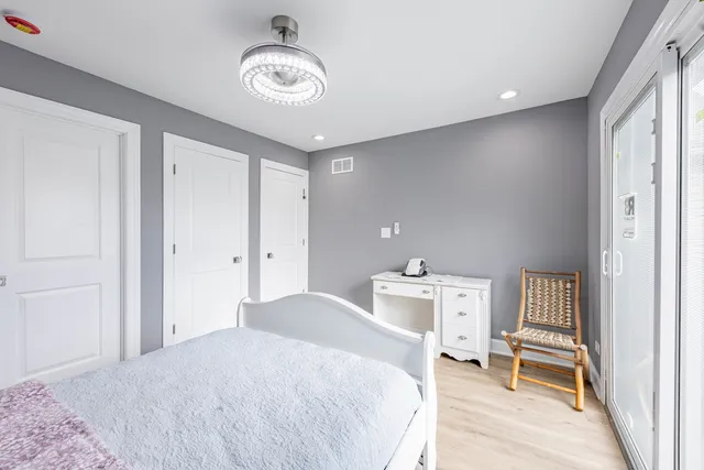 a bedroom with a bed and a chandelier