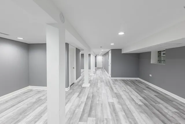 a view of empty room with wooden floor