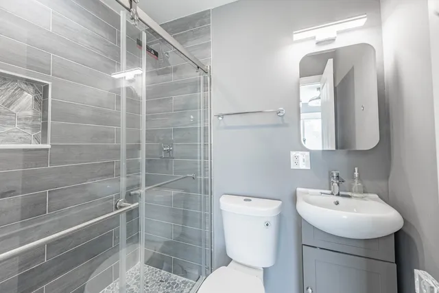 a bathroom with a toilet sink and shower
