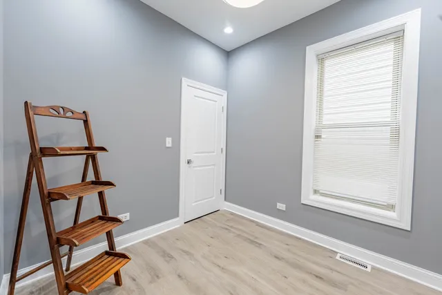 a view of room with window and wooden floor