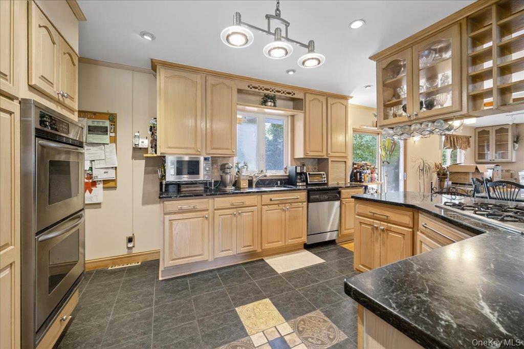 11 Merriewold Lane North Monroe, NY 10950 - Photo 11 of 48 Kitchen with hanging light fixtures, stainless steel appliances, light brown cabinetry, recessed lighting, and glass insert cabinets