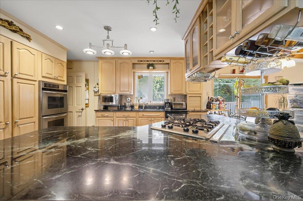 11 Merriewold Lane North Monroe, NY 10950 - Photo 14 of 48 Kitchen with decorative light fixtures, glass insert cabinets, appliances with stainless steel finishes, dark stone counters, and recessed lighting