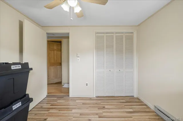 a bedroom with a bed and windows