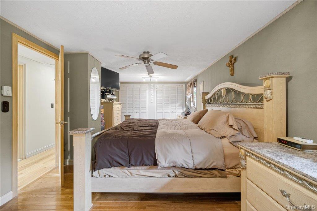 11 Merriewold Lane North Monroe, NY 10950 - Photo 25 of 48 Bedroom featuring wood finished floors, two closets, and a ceiling fan