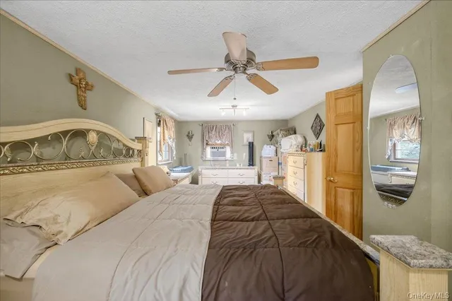 a view of a livingroom with wooden floor and a ceiling fan