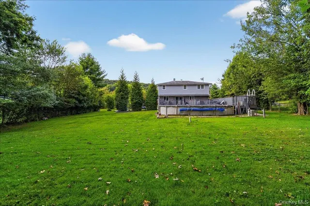 a view of a backyard with a garden and trees