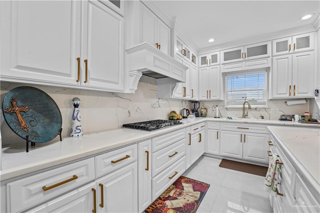7411 East Texas Road Edinburg, TX 78542 - Photo 11 of 20 a kitchen with granite countertop a sink and cabinets