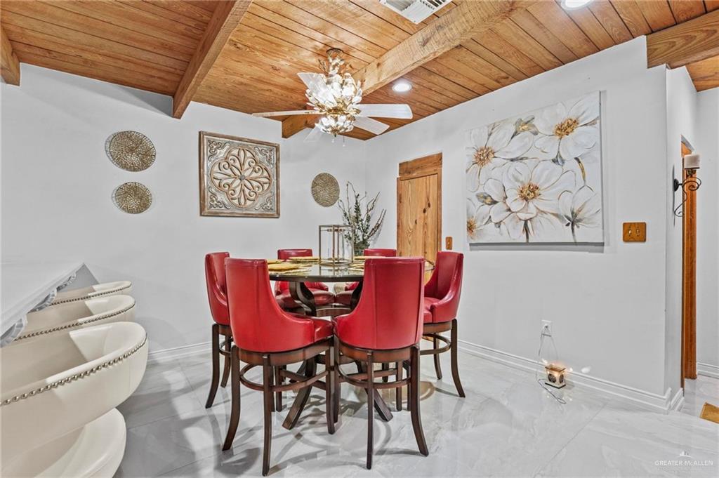 7411 East Texas Road Edinburg, TX 78542 - Photo 13 of 20 a view of a dining room with furniture and chandelier