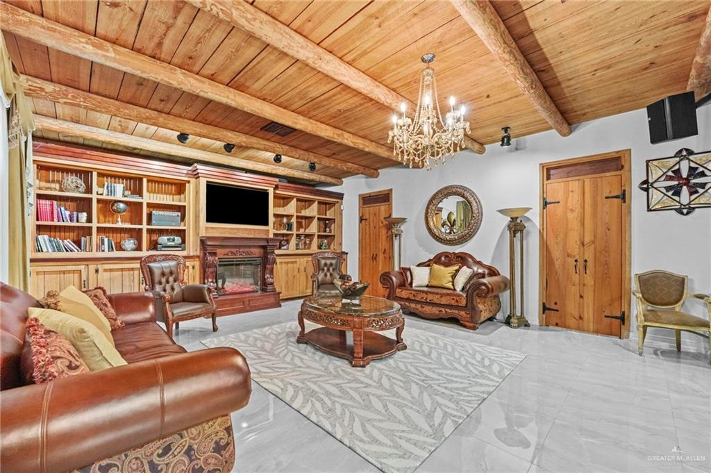 7411 East Texas Road Edinburg, TX 78542 - Photo 17 of 20 a living room with furniture a fireplace and a chandelier