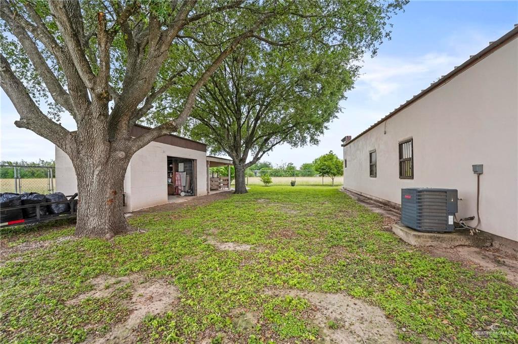 7411 East Texas Road Edinburg, TX 78542 - Photo 19 of 20 a view of a house with backyard and a tree