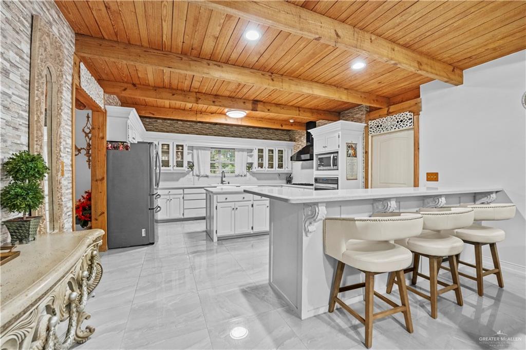 7411 East Texas Road Edinburg, TX 78542 - Photo 3 of 20 a kitchen with a sink and chairs