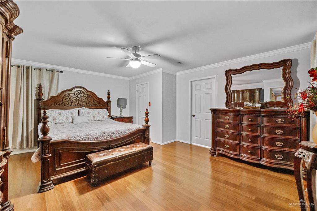 7411 East Texas Road Edinburg, TX 78542 - Photo 4 of 20 a bedroom with a bed and wooden floor