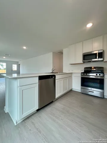 a kitchen with granite countertop a sink and a stove top oven