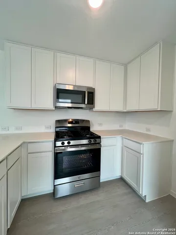 a kitchen with kitchen island a stove a sink and a refrigerator