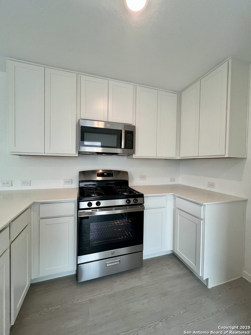9178 Colonel Trail Seguin, TX 78155 - Photo 12 of 59 a kitchen with cabinets stainless steel appliances and a sink