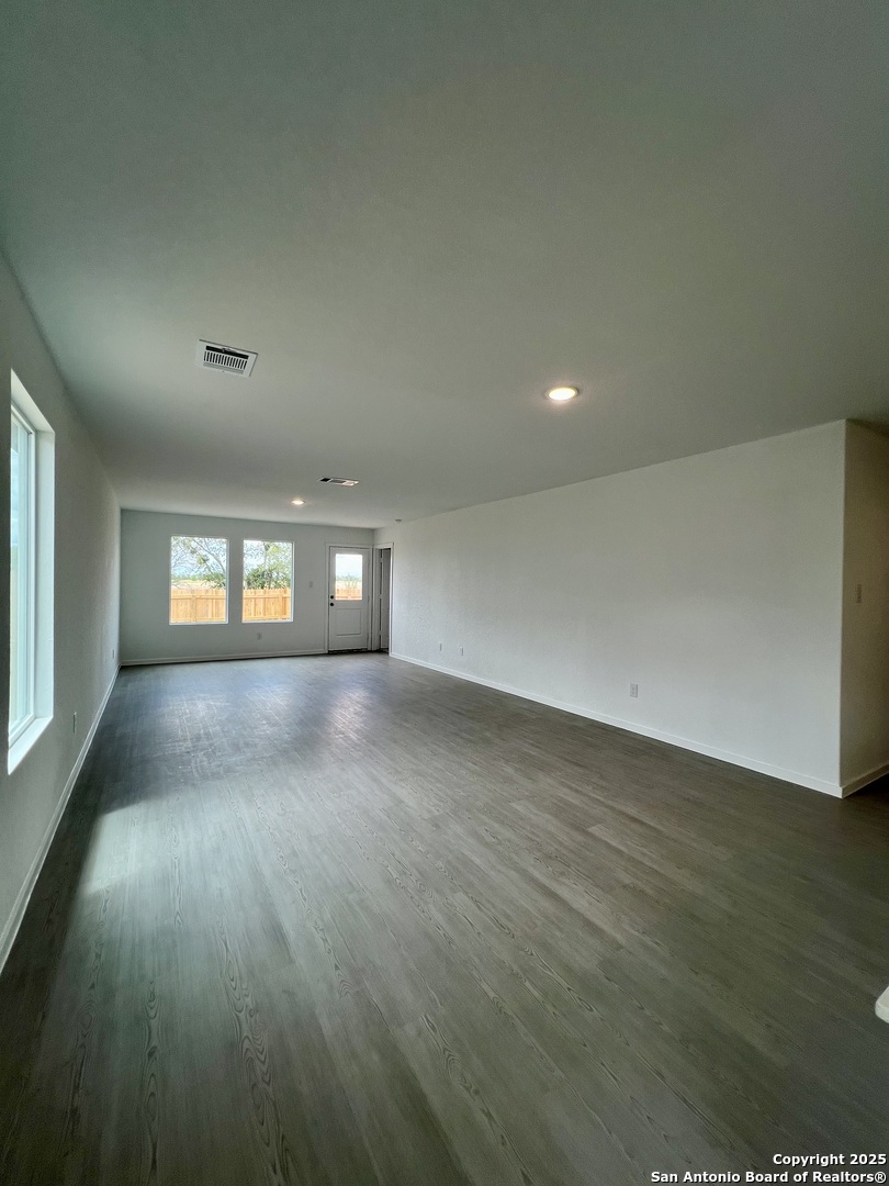 9178 Colonel Trail Seguin, TX 78155 - Photo 17 of 59 an empty room with wooden floor and windows