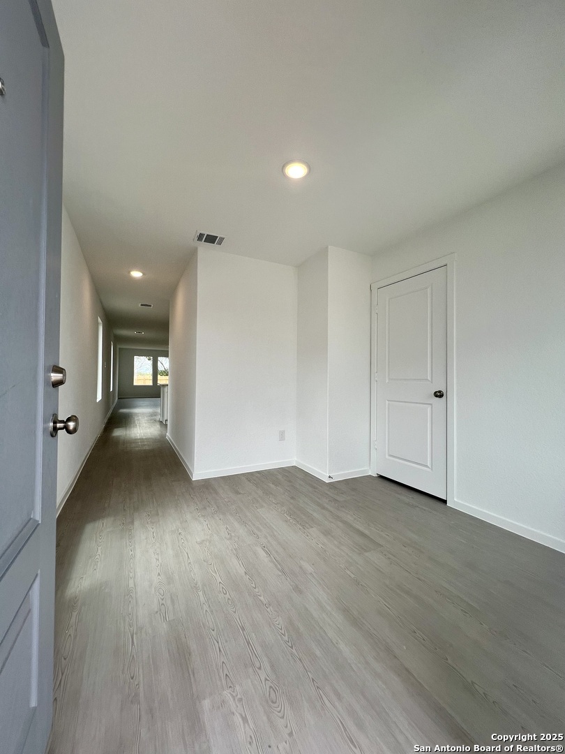 9178 Colonel Trail Seguin, TX 78155 - Photo 3 of 59 a view of a hallway with wooden floor