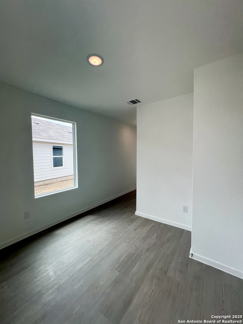 9178 Colonel Trail Seguin, TX 78155 - Photo 4 of 59 an empty room with wooden floor and windows