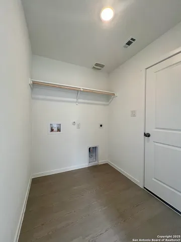 a kitchen with stainless steel appliances a refrigerator a stove top oven a sink and cabinets