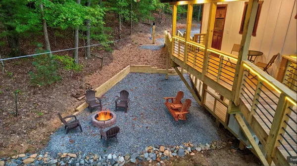 a view of a deck with table and chairs with wooden floor and fence