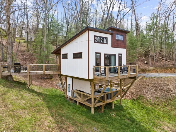 a view of a house with backyard and sitting area