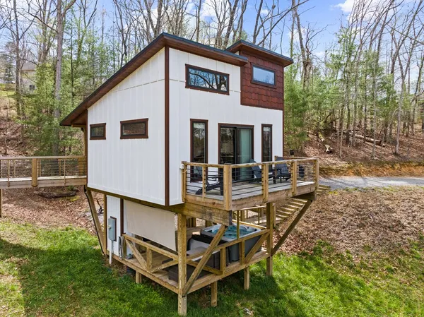 a view of a house with backyard and sitting area