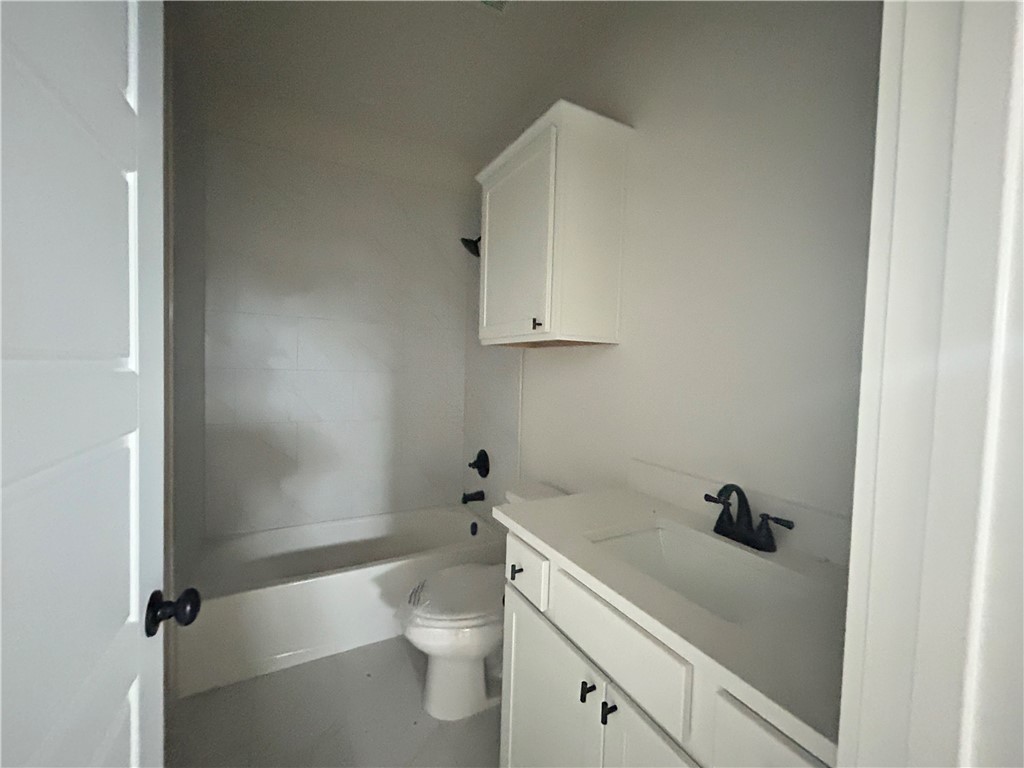 1648 Frontera Ranch College Station, TX 77845 - Photo 14 of 24 a bathroom with a sink a toilet and a mirror