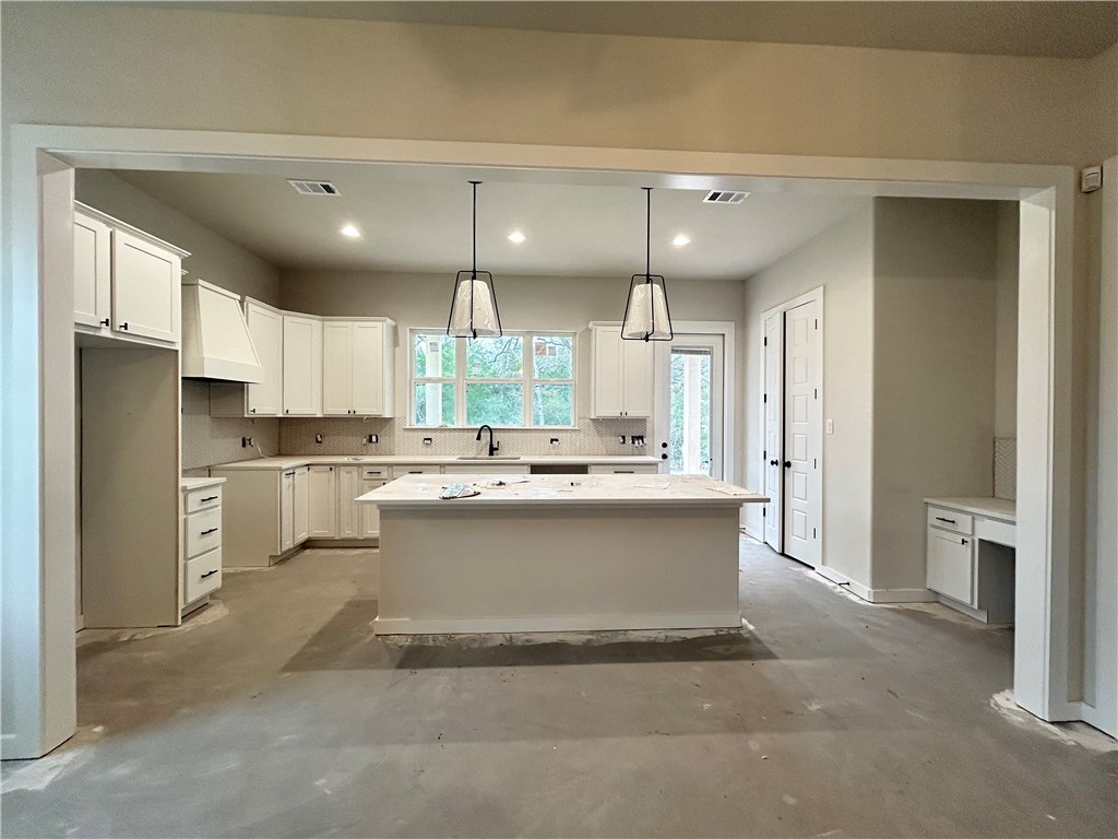 1648 Frontera Ranch College Station, TX 77845 - Photo 3 of 24 a large white kitchen with a sink stainless steel appliances and cabinets