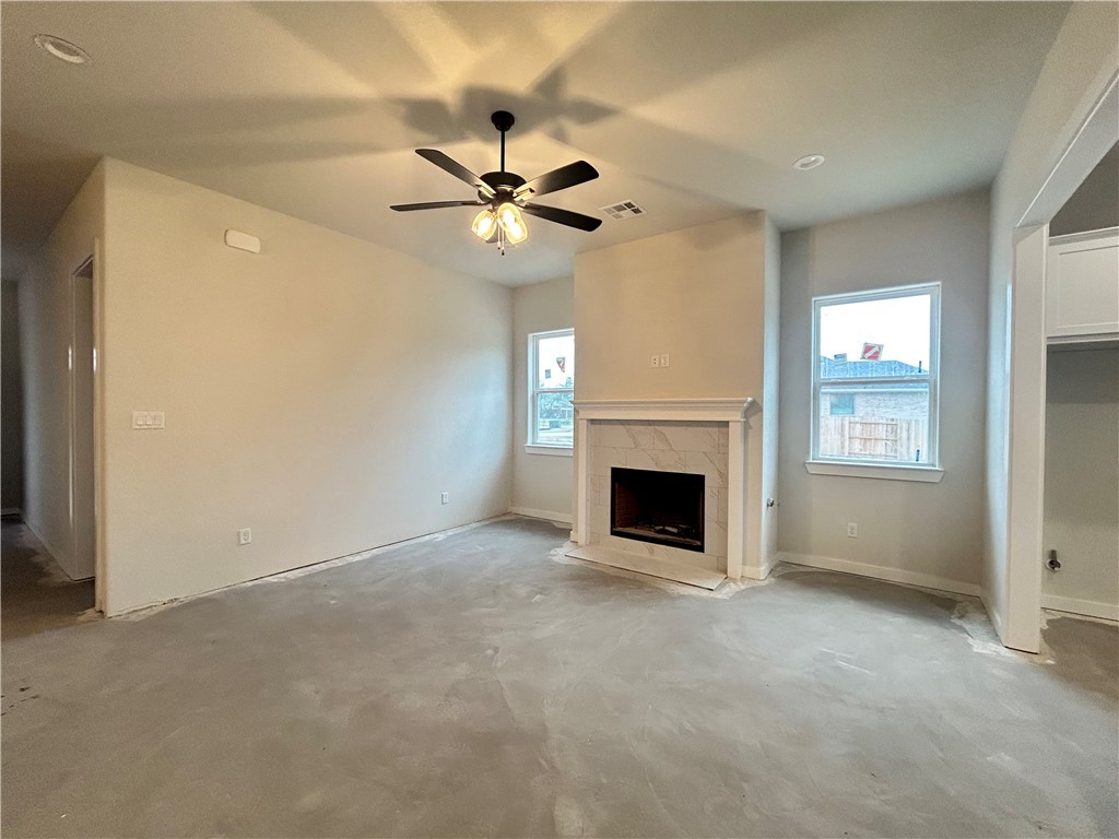 1648 Frontera Ranch College Station, TX 77845 - Photo 4 of 24 a view of an empty room with a fireplace and a window