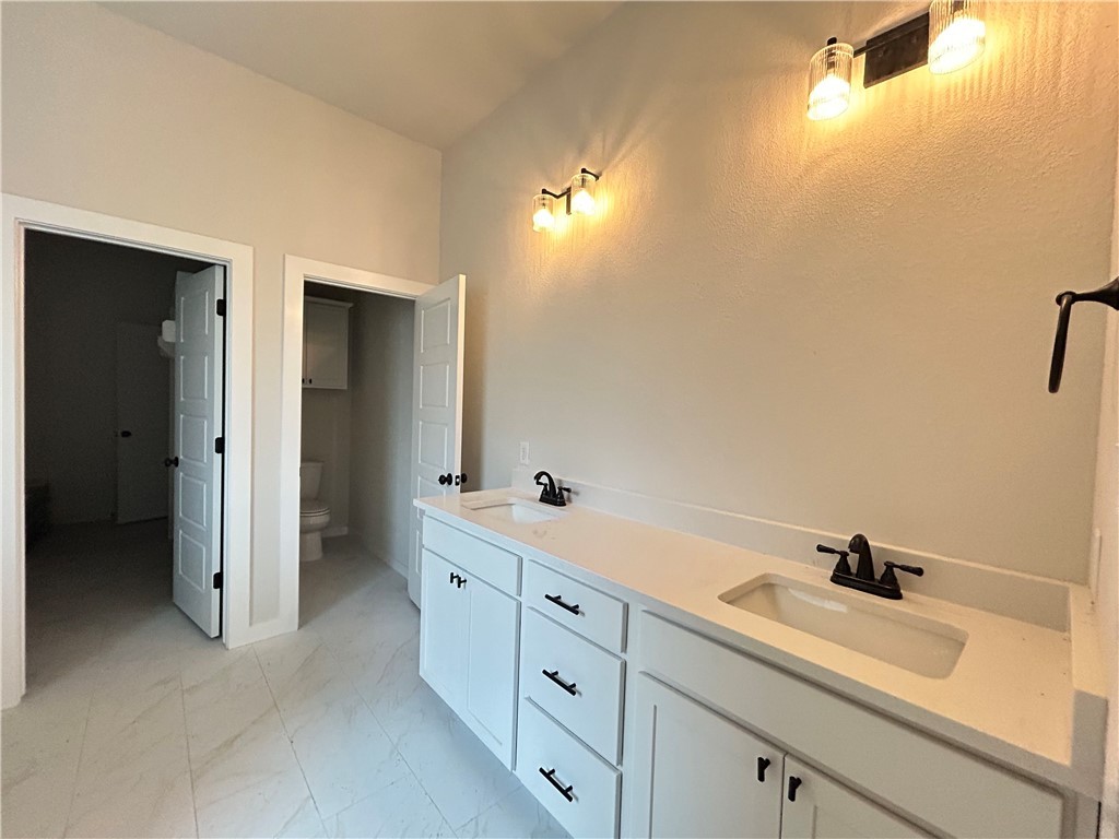 1648 Frontera Ranch College Station, TX 77845 - Photo 7 of 24 a spacious bathroom with a double vanity sink a mirror and a bathtub
