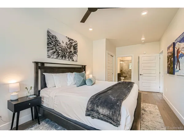 a bedroom with a bed and a painting