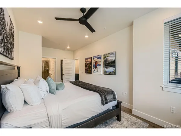a bathroom with a granite countertop sink toilet a large mirror and shower