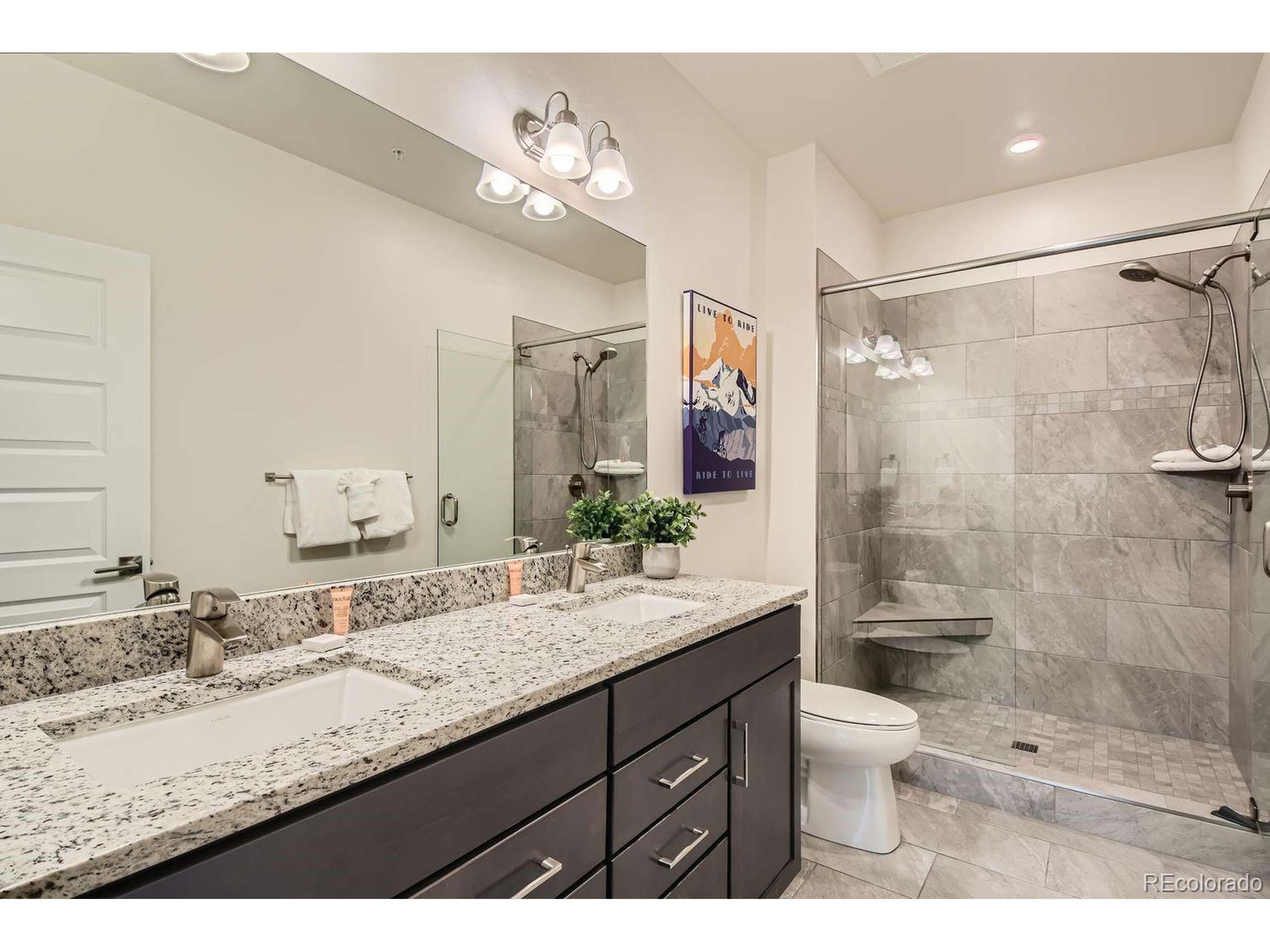 0075 Clearwater Way, Unit 302 Dillon, CO 80435 - Photo 15 of 33 a bathroom with a granite countertop sink toilet a large mirror and shower
