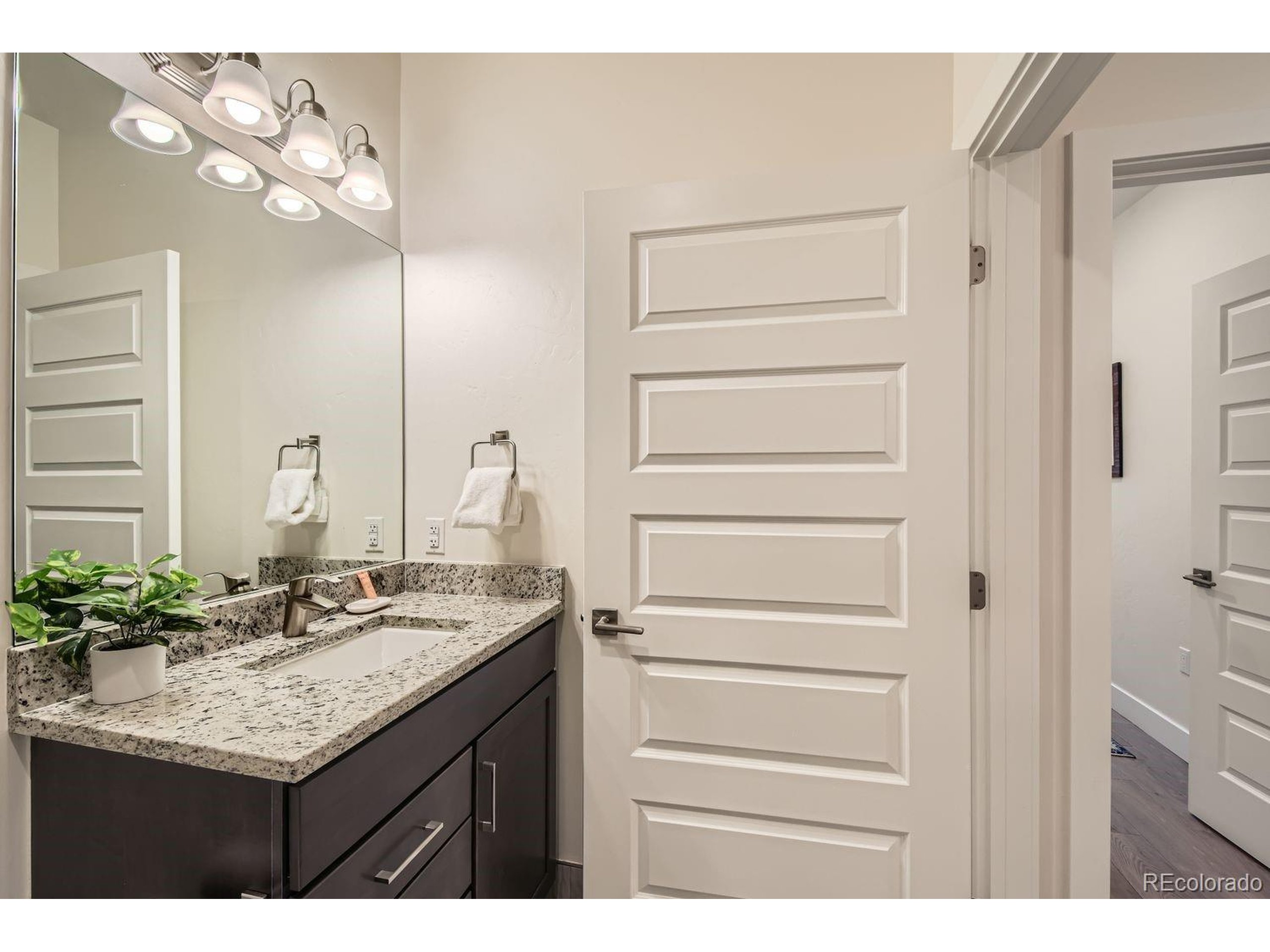0075 Clearwater Way, Unit 302 Dillon, CO 80435 - Photo 18 of 33 a bathroom with a granite countertop sink and a mirror